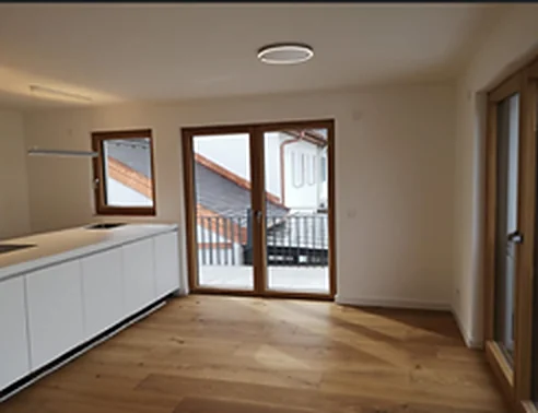 Küche im Dachgeschoss mit Dachflächenfenster und heller Front
